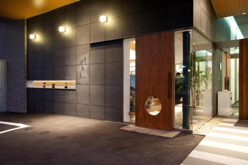 a lobby of a building with a wooden door at Hakata Sunlight Hotel Hinoohgi in Fukuoka