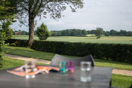 a table with a towel and a glass of water at Buitenplaats De Mechelerhof in Mechelen