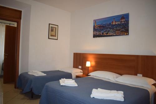 A bed or beds in a room at Hotel Dalmazia