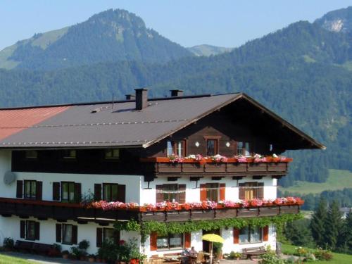 a house with flowers on the balcony of it at Zasserlhof Familie Bamberger in Kössen