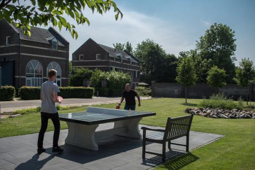 two men playing a game of ping pong in a yard at Buitenplaats De Mechelerhof in Mechelen