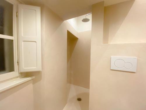 a bathroom with a sink and a lightswitch at OROROSA Lucca City Center Apartment in Lucca