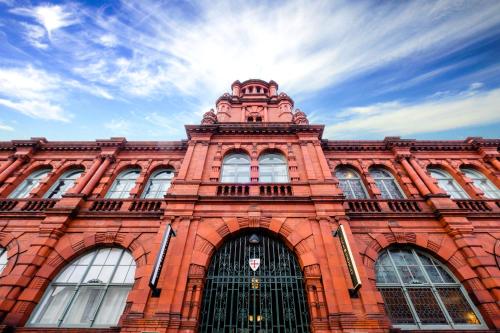 a red brick building with a tower on top of it at Hotel Indigo - Durham by IHG in Durham
