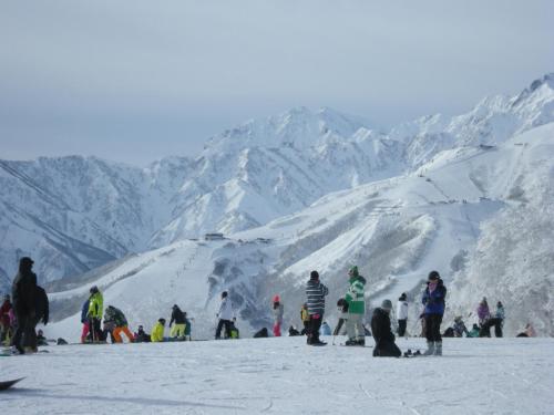 a group of people standing on a snow covered mountain at Villa Komakusa in Hakuba