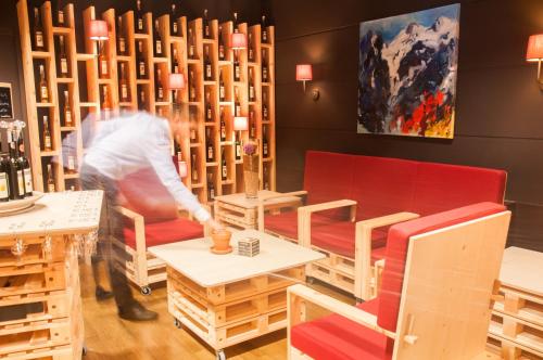 a person in a room with tables and chairs at Bio Hotel Panorama in Malles Venosta