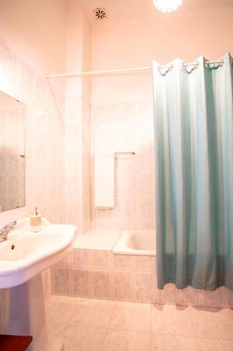 a bathroom with a shower and a sink and a tub at Casa da Várzea in Beiral do Lima