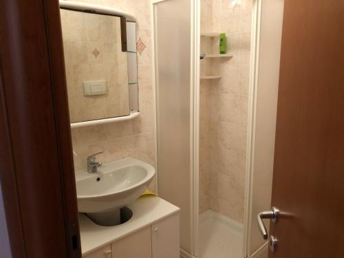 a small bathroom with a sink and a shower at Lito’s house in Villasimius in Villasimius