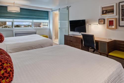 a hotel room with two beds and a television at Hotel Indigo - Memphis Downtown by IHG in Memphis