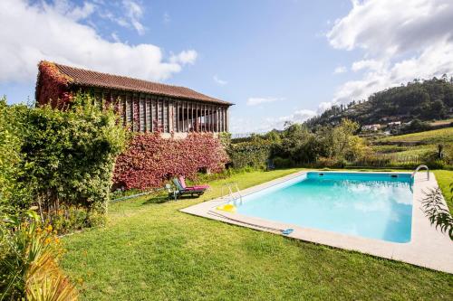 a swimming pool in the yard of a house at Casa da Várzea in Beiral do Lima