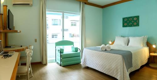 En eller flere senge i et værelse på Solis Praia Hotel Itapema