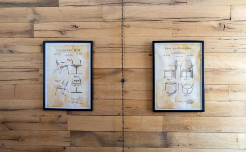 two framed drawings of wine glasses on a wall at Kazbegi cabins in Stepantsminda