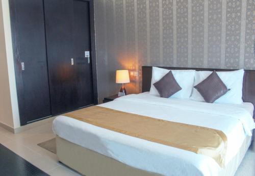 a hotel room with a bed and a dresser at Dunes Hotel Apartment Oud Metha, Bur Dubai in Dubai