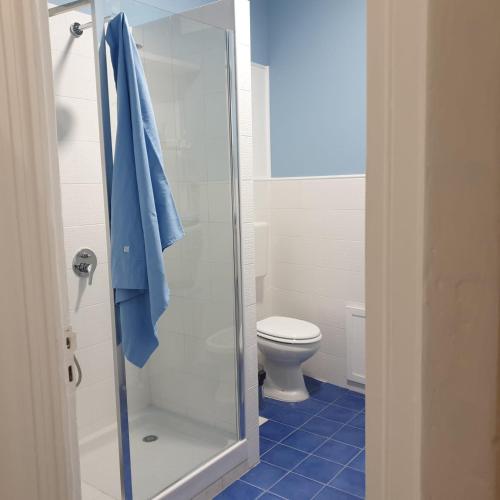 a bathroom with a toilet and a glass shower at Opera Prima 28 in Palermo