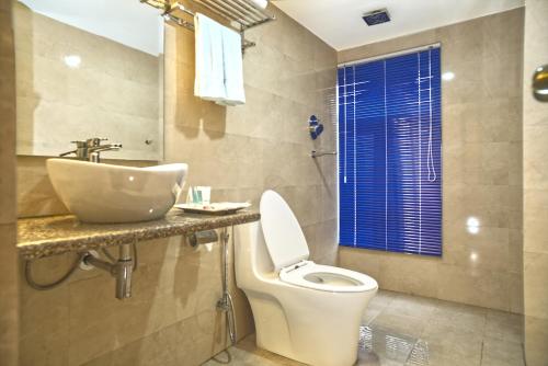 a bathroom with a toilet and a sink at Satkar Hotel and Spa in Kathmandu