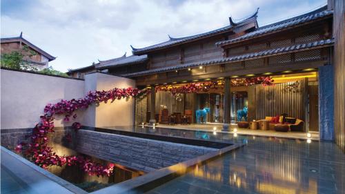 a house with a pool in front of it at Hotel Indigo Lijiang Ancient Town, an IHG Hotel in Lijiang