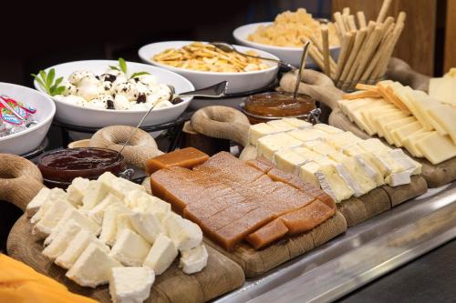 a buffet with cheese and other foods on a table at Sol Pelicanos Ocas in Benidorm