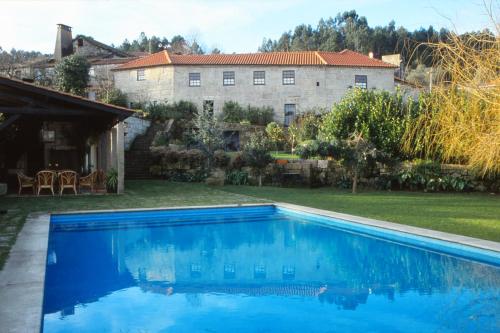 a swimming pool in the yard of a house at Casa Aido Santo in Pinheiro de Lafões