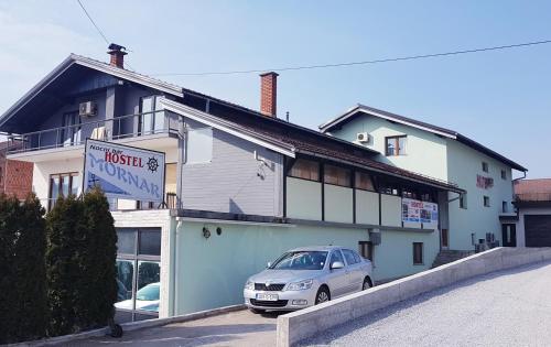 a car parked in front of a building at Hostel Mornar in Velika Kladuša