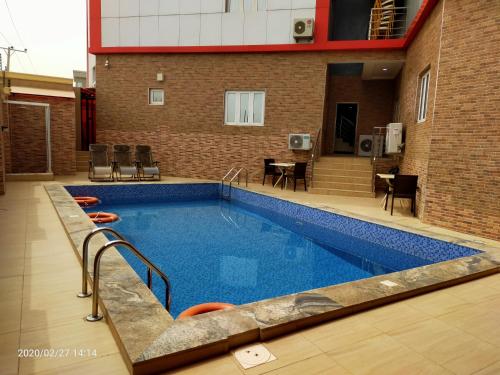 une grande piscine en face d'un bâtiment dans l'établissement Alim Royal Hotel and Suite, à Abuja