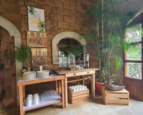a room with a counter with plates and a mirror at Spacio Caliraya Bed & Breakfast in Lumban