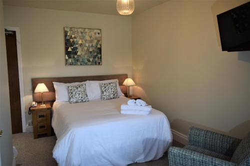 a bedroom with a bed with towels on it at Wye Valley Hotel in Tintern