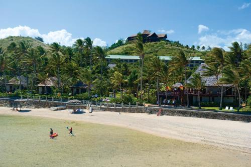 a group of people playing on the beach at Outrigger Fiji Beach Resort in Korotogo