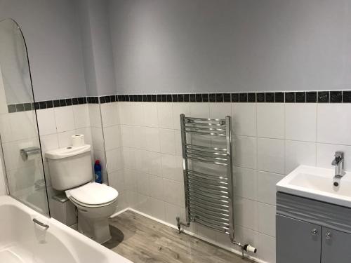 a bathroom with a toilet and a sink at Flat Five, 212 Eaglesham Road, East Kilbride, Glasgow in East Kilbride