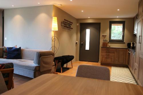 a living room with a couch and a kitchen at Mountain Suite in Brienz-Brinzauls