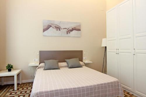 a bedroom with a bed with a checkered blanket at GIRONA - Modernist apartments next to Paseo de Gracia in Barcelona