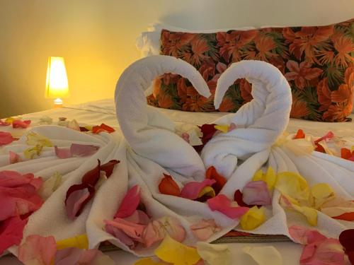 two swans made out of towels on a bed at Pousada Penedo in Penedo