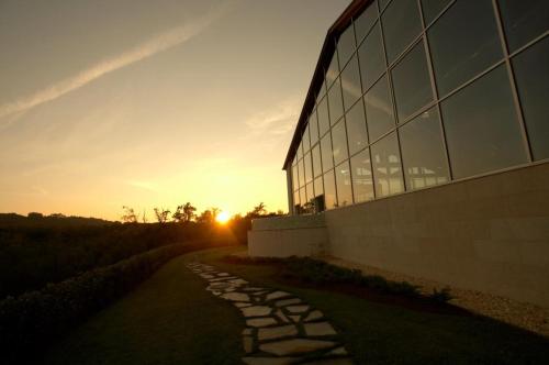 a building with a stone path next to a building at Hotel Spa Attica21 Vilalba in Villalba
