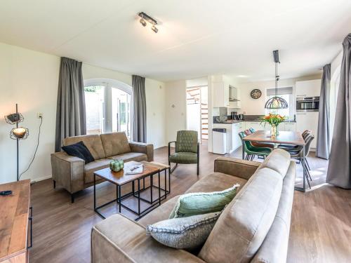 a living room with a couch and a table at Holiday Home Citta Romana-1 by Interhome in Hellevoetsluis