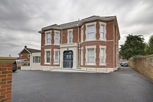 a large brick house with a driveway in front of it at Highfield Bed & Breakfast in Lymington