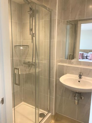 a bathroom with a shower and a sink at Monarch Hotel in Bridlington