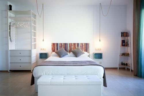 a bedroom with a large white bed and a window at Mataro Luxury Apartments in Mataró