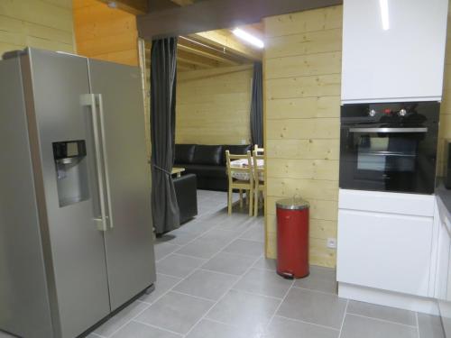 a kitchen with a refrigerator and a living room at Domaine Du Sauveur in Luz-Saint-Sauveur