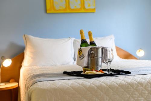 two bottles of champagne in a bucket on a bed at Solis Praia Hotel Itapema in Itapema