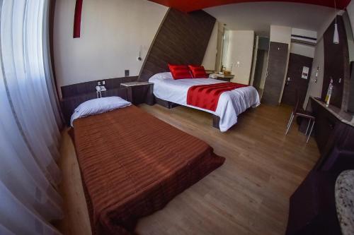 a bedroom with a bed and a bench in it at La Moraleja Love hotel in Mexico City