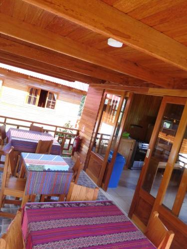 a room with tables and chairs in a house at Chontaqui Eco-Lodge in Oxapampa