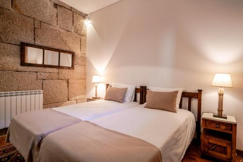 En eller flere senge i et værelse på Quinta das Lamas - Antiga Adega