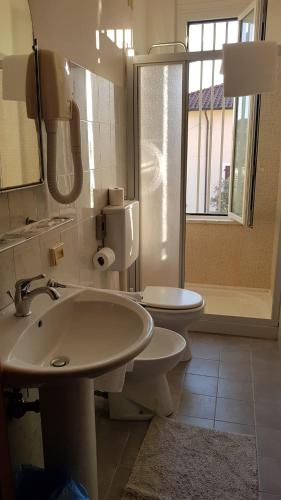 a bathroom with a sink and a toilet at Hotel Patrizia in Marina di Massa