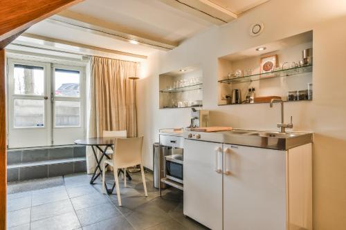 a kitchen with a sink and a table at Amsterdam Canal Guest Apartment in Amsterdam