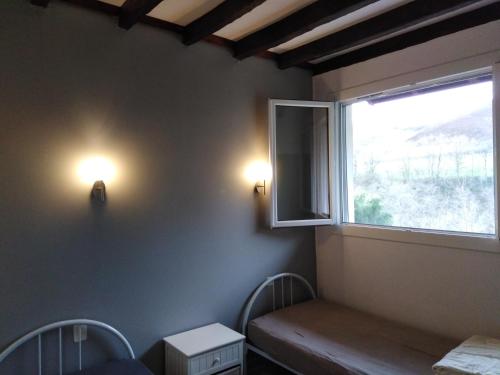a room with two chairs and a window at GITE IBARLA BORDA in Bidarray