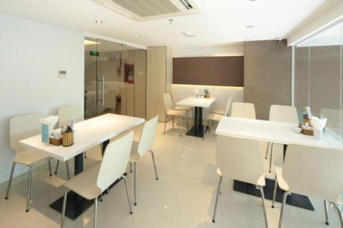 a dining room with white tables and white chairs at Tristar Hotel in Nha Trang