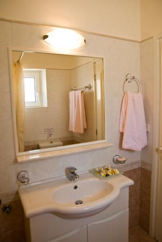 a bathroom with a sink and a mirror at Kallicrates Village in Frangokastello