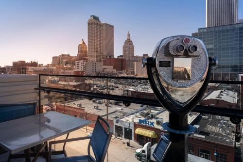 a mirror on a balcony with a view of a city at Hotel Indigo Tulsa DWTN/Entertainment Area in Tulsa