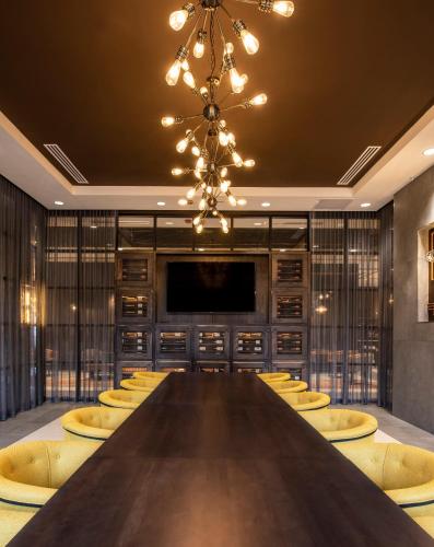 a large conference room with a large table and yellow chairs at Hotel Indigo Tulsa DWTN/Entertainment Area in Tulsa
