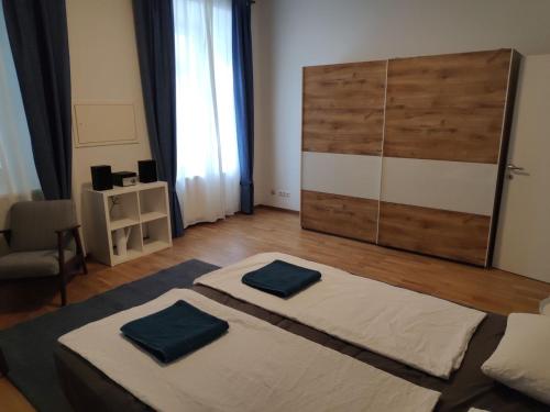 a bedroom with a bed with two blue pillows on it at Flataid Apartment Reitschulgasse - City Center - Jakominiplatz in Graz