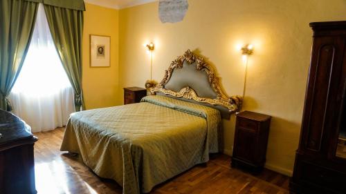 1 dormitorio con 1 cama con marco dorado en Antica Dimora della Racchetta, en Ferrara