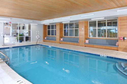 a large swimming pool with blue water in a hotel at Hotel Indigo Orange Beach - Gulf Shores by IHG in Gulf Shores